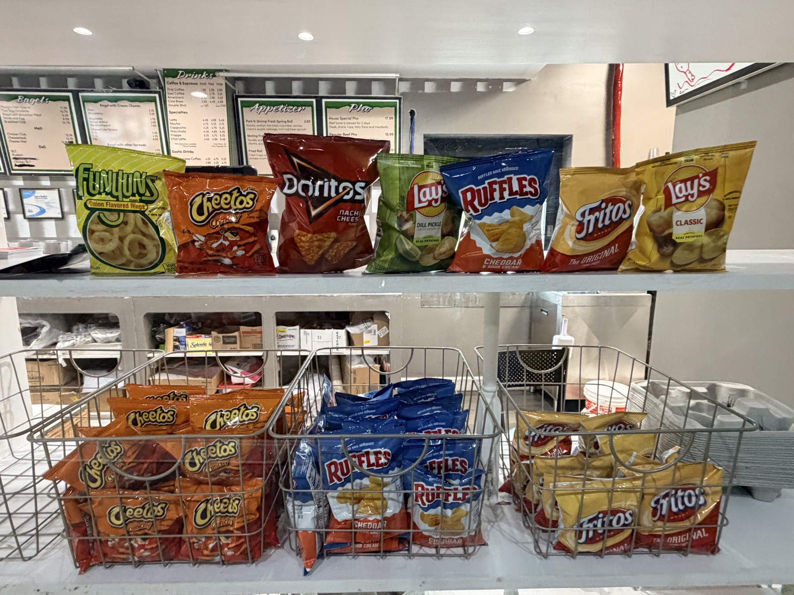 Snacks and menu boards at the Donuts Pho Bagels counter